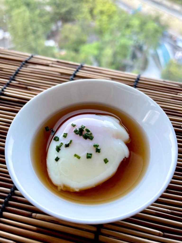 onsen egg on a white sauce dish