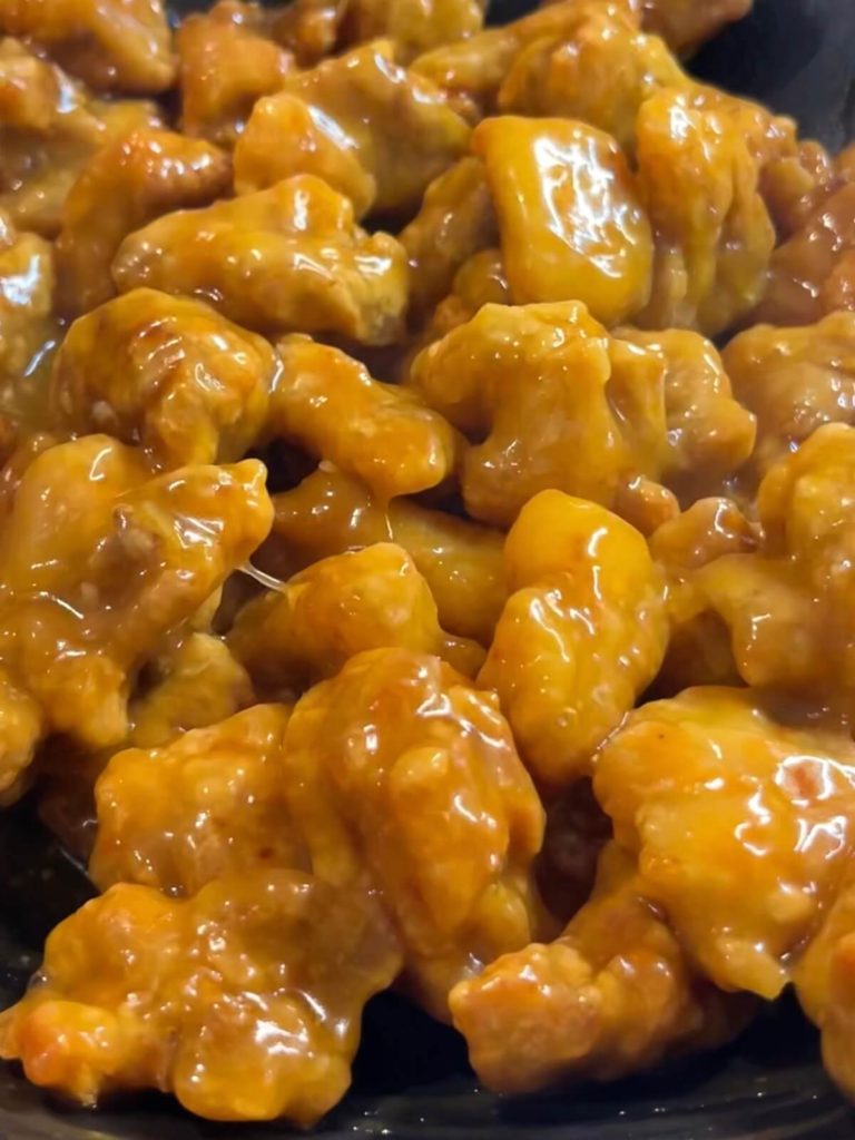 chicken coated in a glossy orange sauce